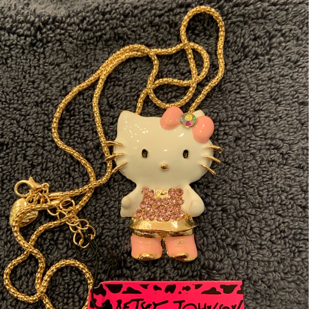 On sale! BJ Hello Kitty necklace with a pink jumper, white blouse. Drop is 12”.